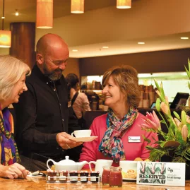 Guests enjoying friendly service at a café during an Ultimate coach tour