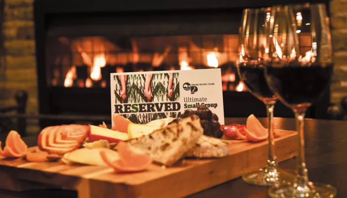 Charcuterie platter and wine served with a reserved sign for Ultimate Small Group Touring