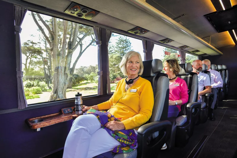 Passenger enjoying panoramic views from a spacious window seat on the Ultimate coach