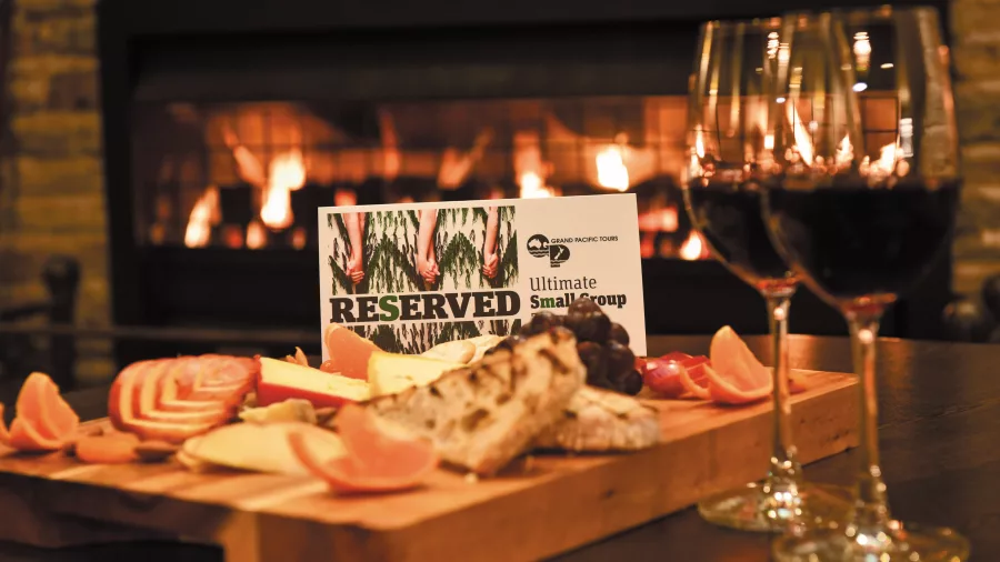 Charcuterie platter and wine served with a reserved sign for Ultimate Small Group Touring