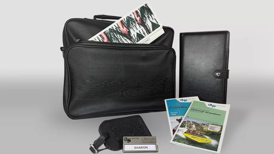 Welcome pack with itinerary, name tag, and travel guides for Grand Pacific’s Ultimate Coach Tour