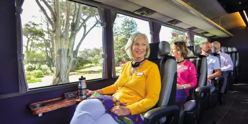 Passenger enjoying panoramic views from a spacious window seat on the Ultimate coach