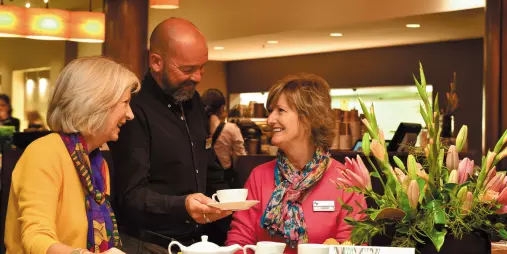 Guests enjoying friendly service at a café during an Ultimate coach tour