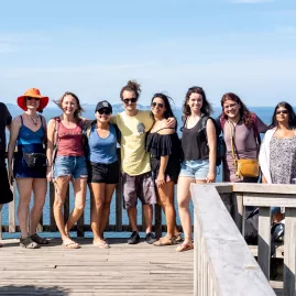 Group of travellers enjoying scenic views from a lookout on the Coromandel Peninsula, New Zealand.