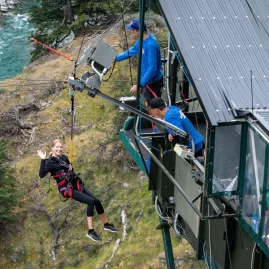 Traveller launching off the Queenstown Canyon Swing platform over the Shotover River, New Zealand.