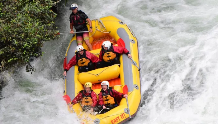 Adventurers white water rafting down a rapid on the Kaituna River in New Zealand