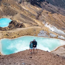 Hikers standing above the Emerald Lakes on the Tongariro Alpine Crossing