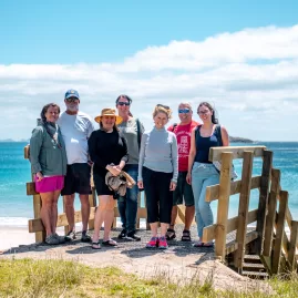 Group enjoying a coastal walk in the Bay of Islands, New Zealand