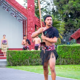 Māori warrior performs traditional wero challenge at Te Puia, Rotorua
