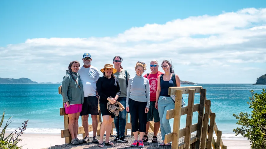 Group enjoying a coastal walk in the Bay of Islands, New Zealand