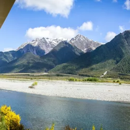 Scenic view from the TranzAlpine train over river and Southern Alps