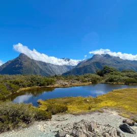 Alpine tarn reflecting mountains at Key Summit on the Routeburn Track in Fiordland