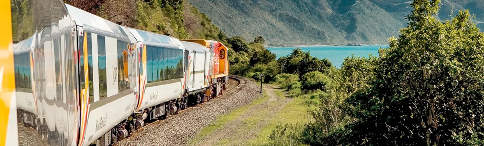Coastal Pacific train passing through Canterbury with ocean and mountain views