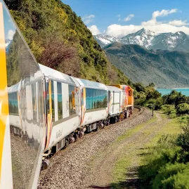 Coastal Pacific train passing through Canterbury with ocean and mountain views