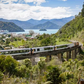 Coastal Pacific train crossing viaduct near Picton with Marlborough Sounds in background