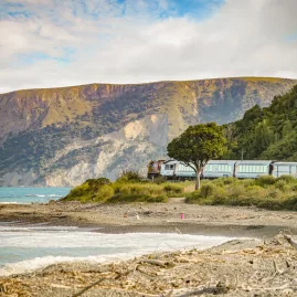 Coastal Pacific train passing along the Kaikōura coastline in South Island, New Zealand