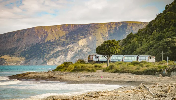 Coastal Pacific train passing along the Kaikōura coastline in South Island, New Zealand