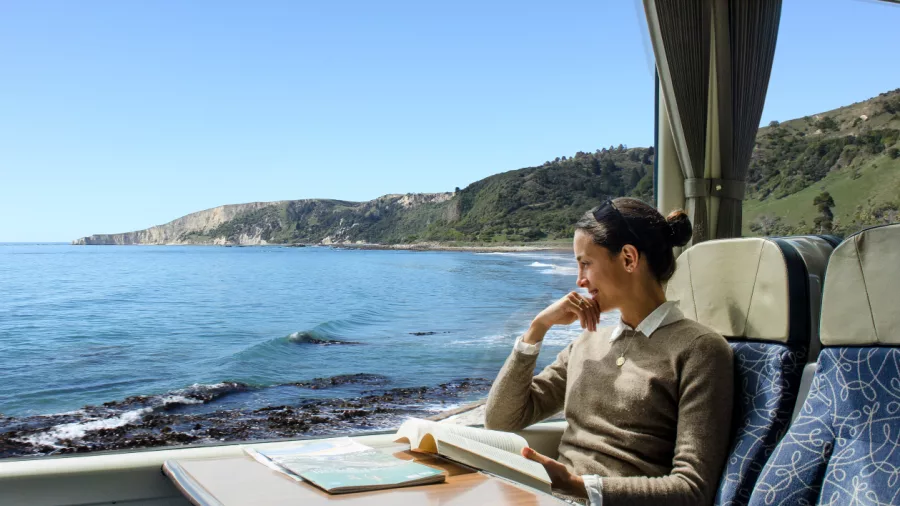 Woman enjoying sea view on Coastal Pacific train