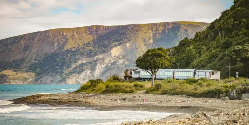 Coastal Pacific train passing along the Kaikōura coastline in South Island, New Zealand