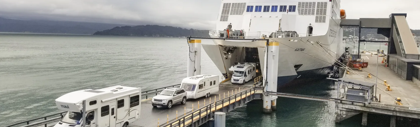 Campervans and vehicles disembark Interislander Kaitaki ferry in Picton