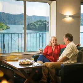 Couple enjoys drinks with ocean views in Interislander Premium Lounge