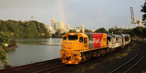 Northern Explorer train leaving Auckland City, Sky Tower