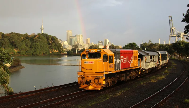 Northern Explorer train leaving Auckland City, Sky Tower