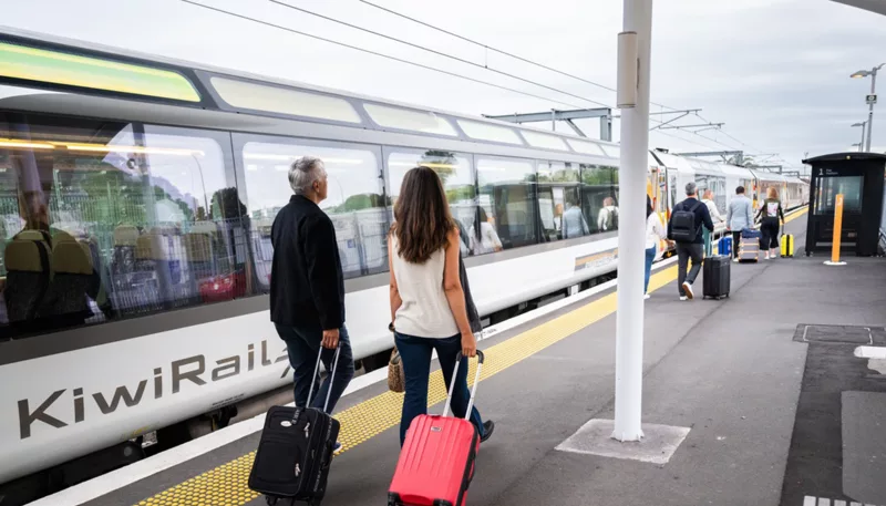 Couple with luggage ready to board the Northern Explorer Train, Auckland, North Island
