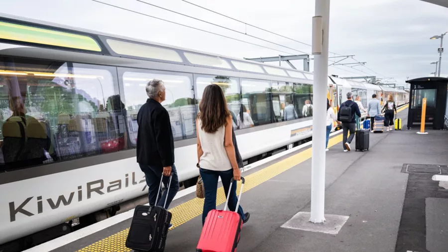 Couple with luggage ready to board the Northern Explorer Train, Auckland, North Island