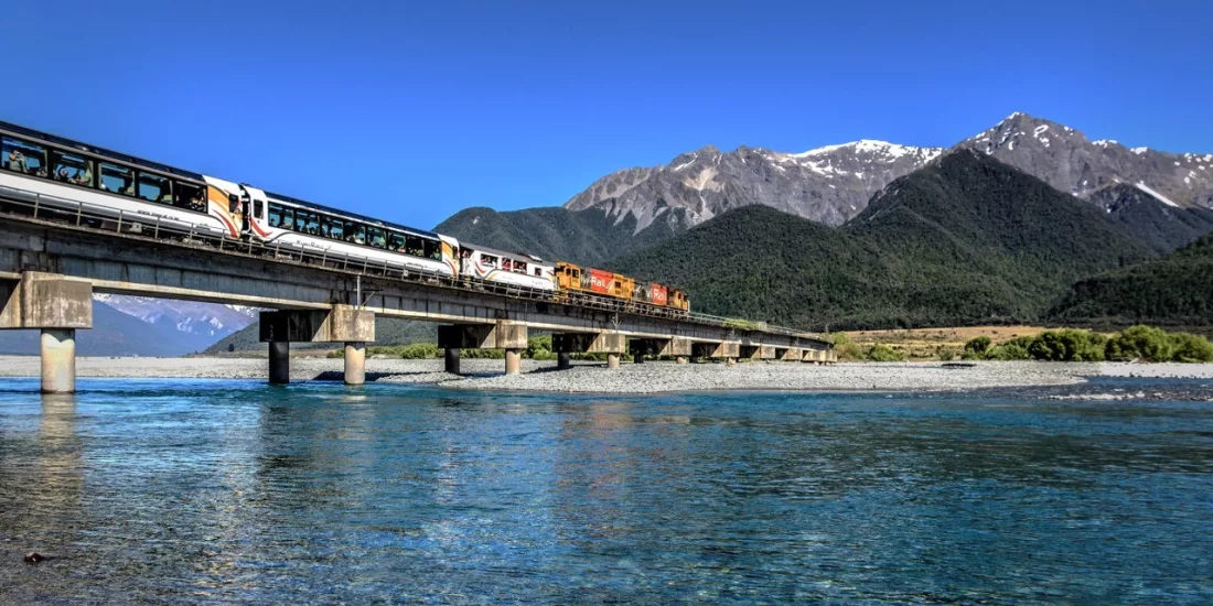 TranzAlpine train crossing Waimakariri River on a clear day