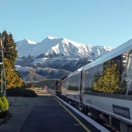 TranzAlpine train at Springfield Station with Southern Alps behind