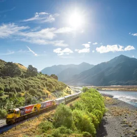 TranzAlpine Train by Waimakariri River in Canterbury near Christchurch