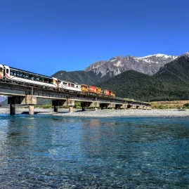 TranzAlpine train crossing Waimakariri River on a clear day
