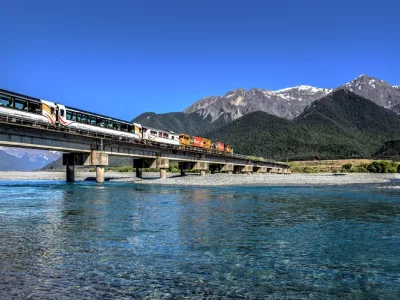 TranzAlpine train crossing Waimakariri River on a clear day