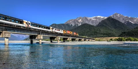 TranzAlpine train crossing Waimakariri River on a clear day