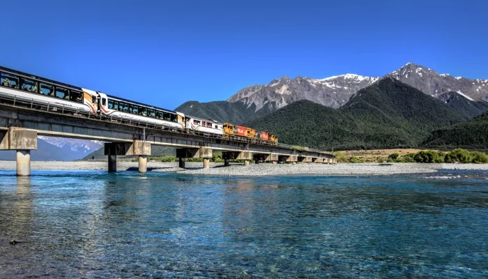 TranzAlpine train crossing Waimakariri River on a clear day