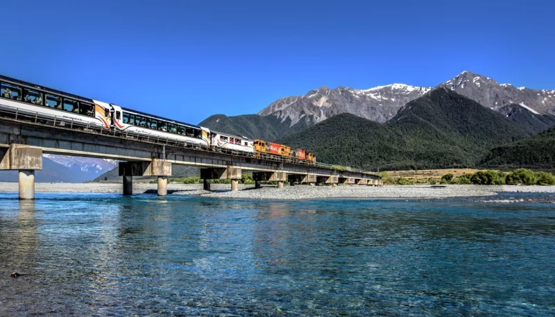 TranzAlpine train crossing Waimakariri River on a clear day