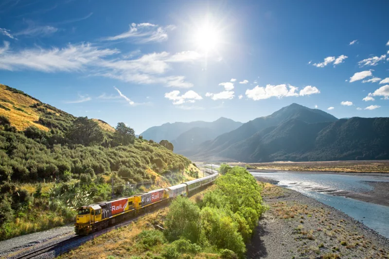 TranzAlpine Train by Waimakariri River in Canterbury near Christchurch