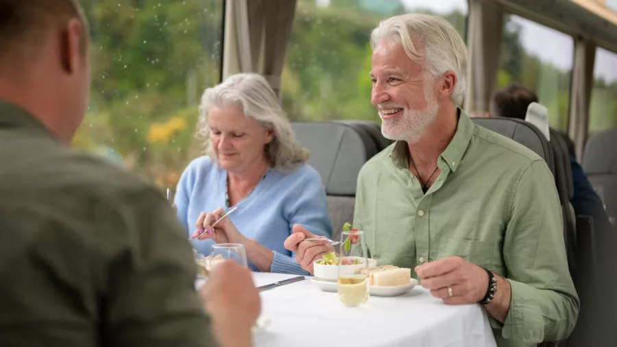 Couple enjoying lunch with views aboard TranzAlpine train