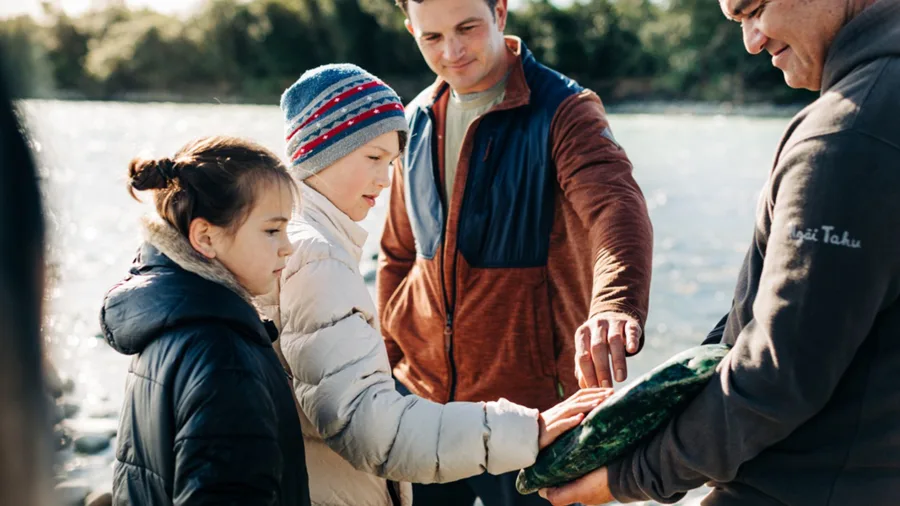 Family discovering greenstone on West Coast TranzAlpine tour