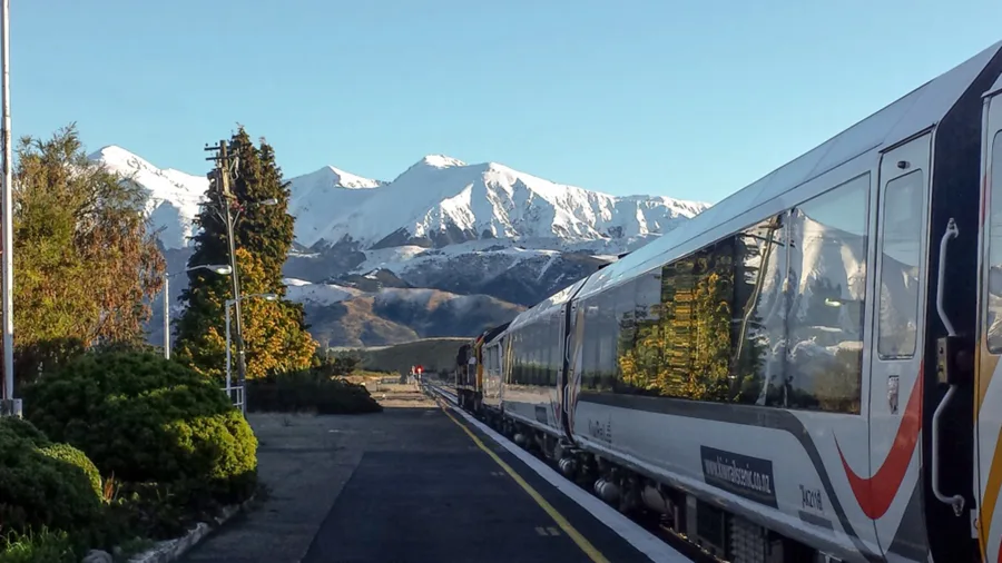 TranzAlpine train at Springfield Station with Southern Alps behind