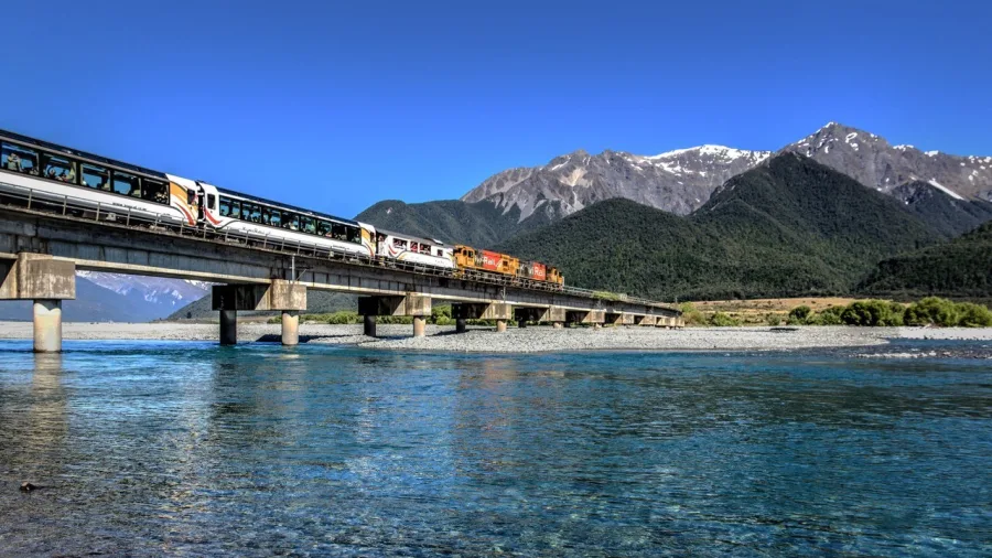 TranzAlpine train crossing Waimakariri River on a clear day