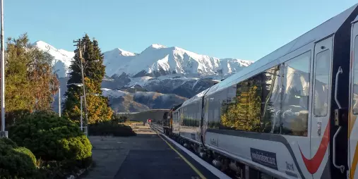TranzAlpine train at Springfield Station with Southern Alps behind