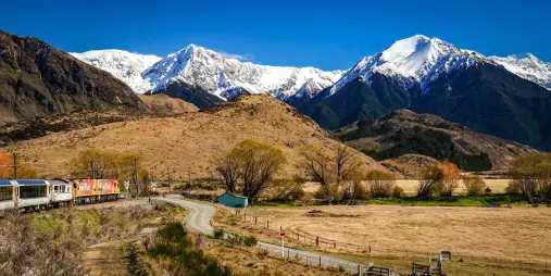 TranzAlpine train near Cass with snow-capped mountains