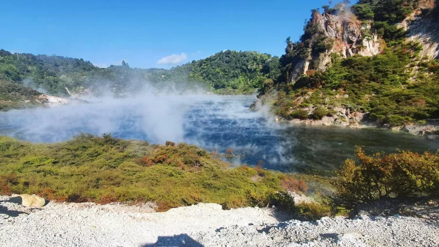 Steam rising from Frying Pan Lake with Cathedral Rocks in Waimangu Volcanic Valley near Rotorua
