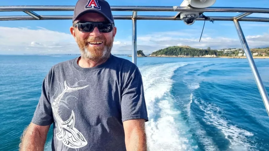 Smiling guest aboard boat tour in Abel Tasman National Park