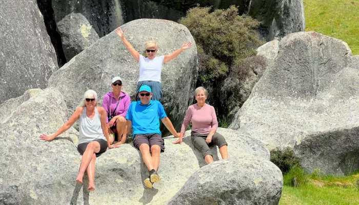 Group of guests relaxing on boulders at Castle Hill in Canterbury