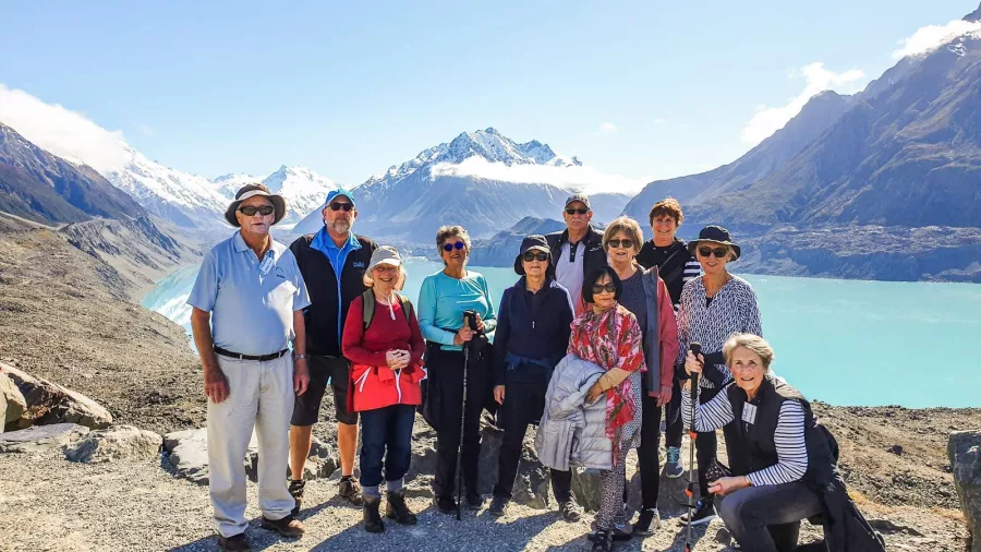 Tour group overlooking Tasman Glacier lake in Aoraki Mt Cook National Park