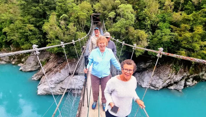MoaTrek guests crossing the swing bridge over Blue Pools near Makarora