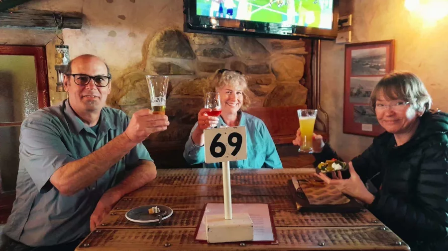 Guests enjoying drinks at the Cardrona Hotel pub during a MoaTrek tour